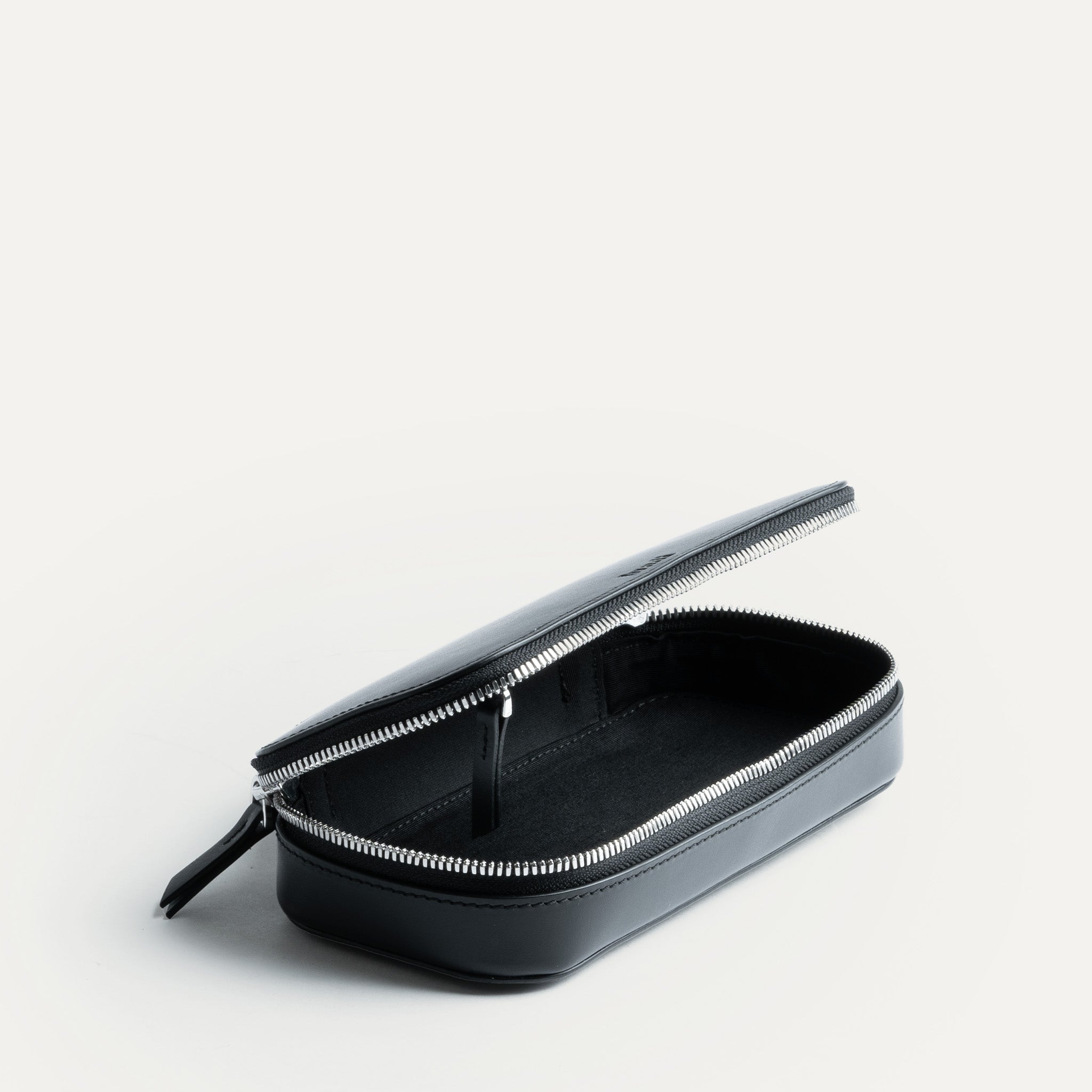 Trousse de toilette homme robuste en cuir noir.