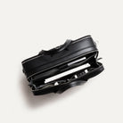 Sac à main homme en toile et cuir noir montrant son organisation intérieure pratique.