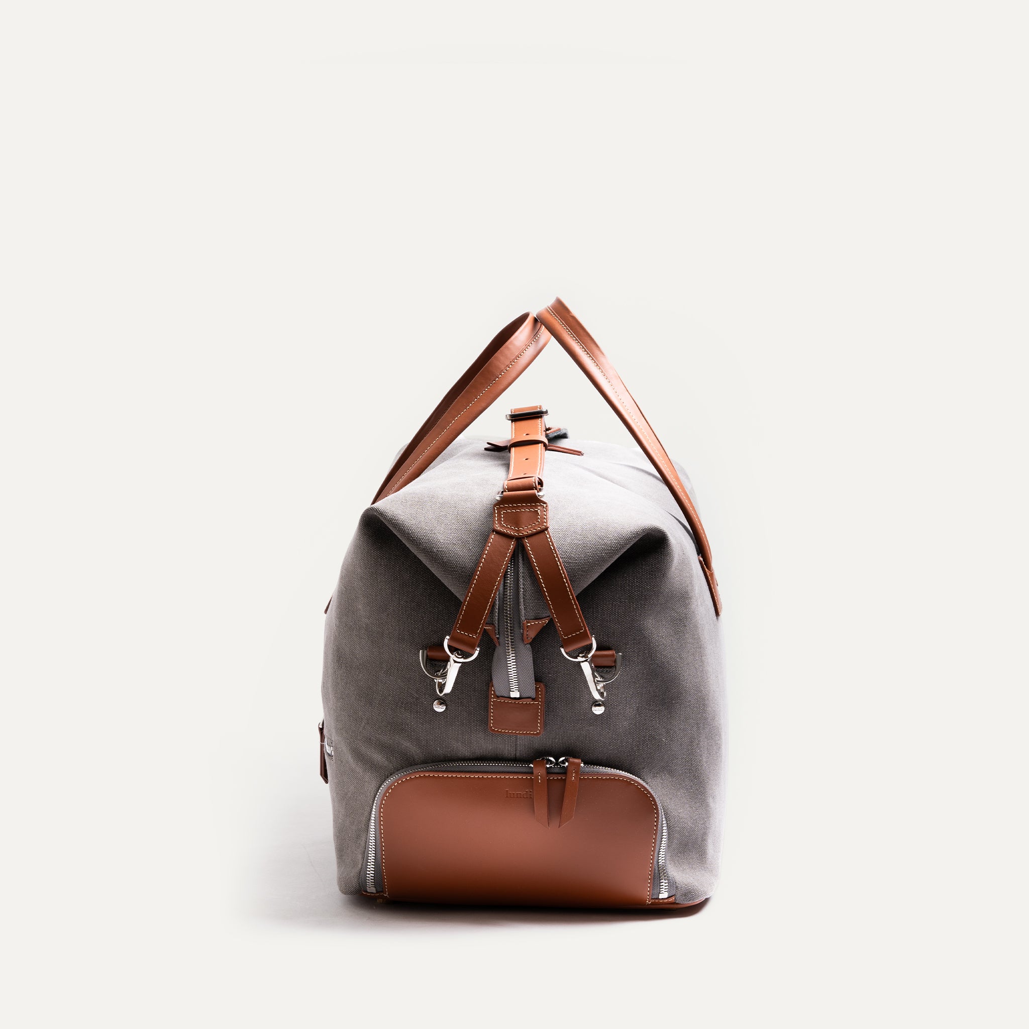 Leather travel bags for men with a compact profile suitable for the aircraft cabin.