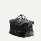 Sac de voyage en toile noire pour homme ou femme, design sobre et compartiments zippés pour une utilisation quotidienne ou en déplacement.