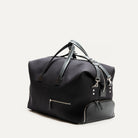 Sac de voyage en cuir et toile noir à l'allure raffiné et luxueux parfait pour embarquer avec élégance lors de votre voyage.