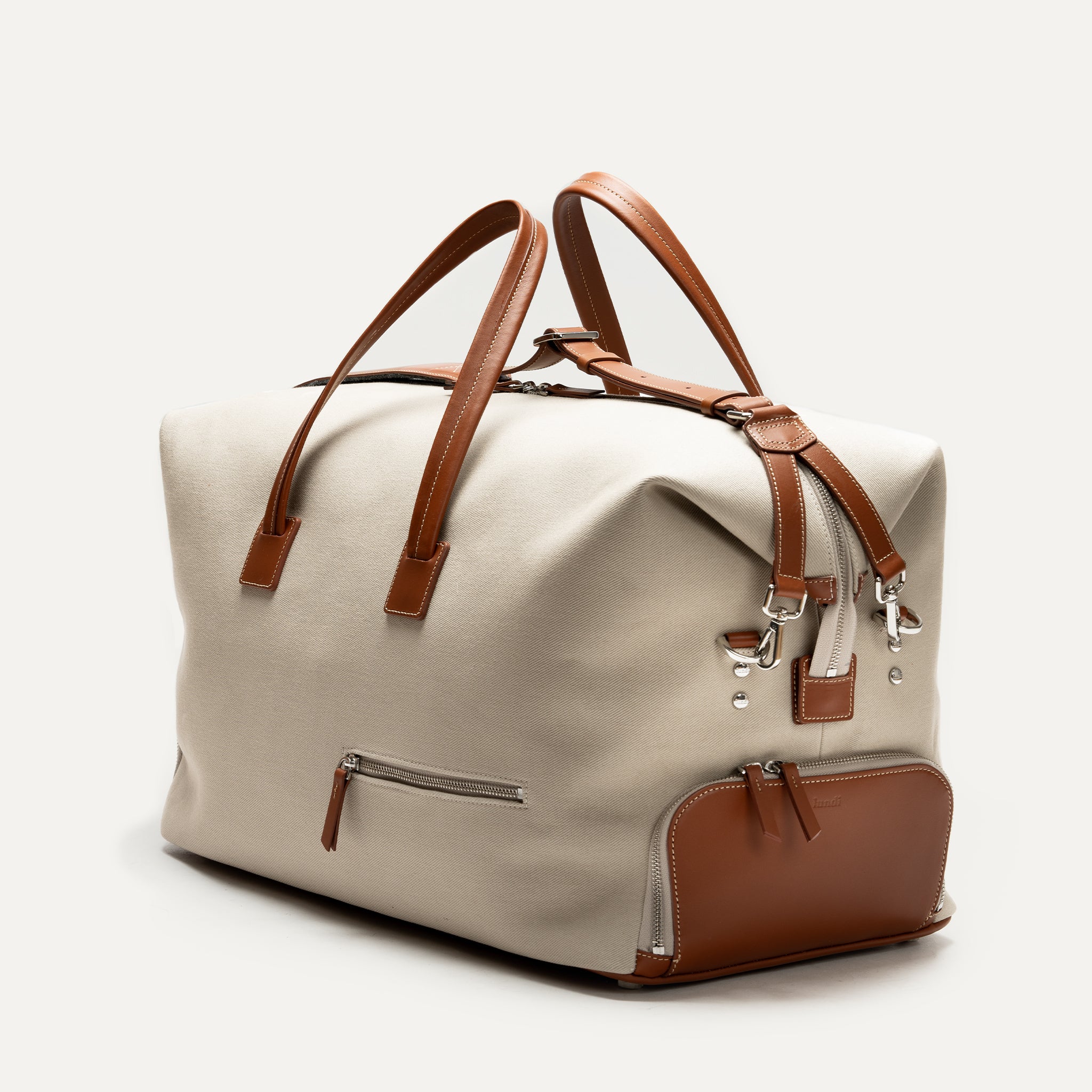 Sac de voyage pour homme en toile beige et cuir marron, modèle REMINGTON avec anses élégantes.