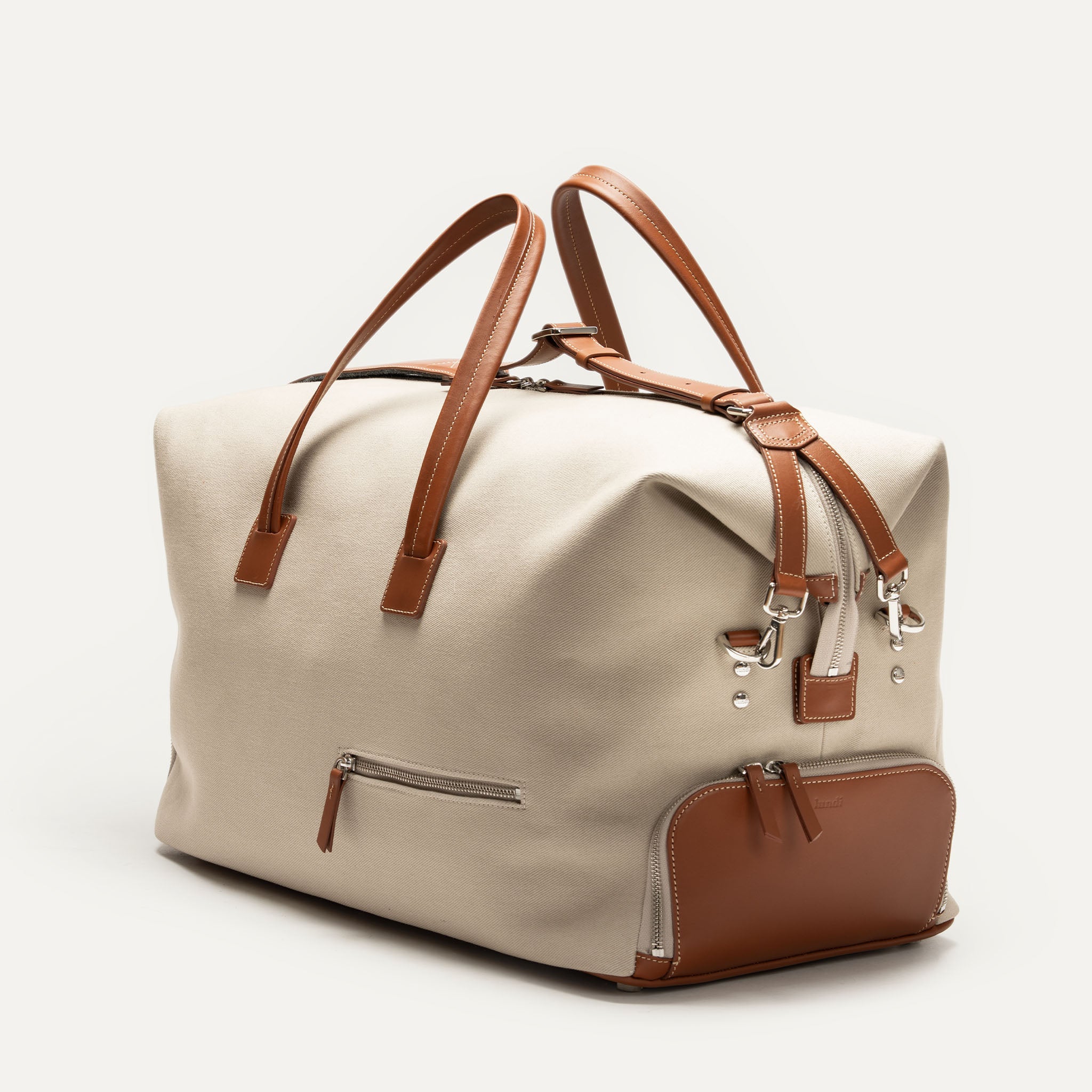 Sac de voyage pour homme en toile beige et cuir marron, modèle REMINGTON avec anses élégantes.