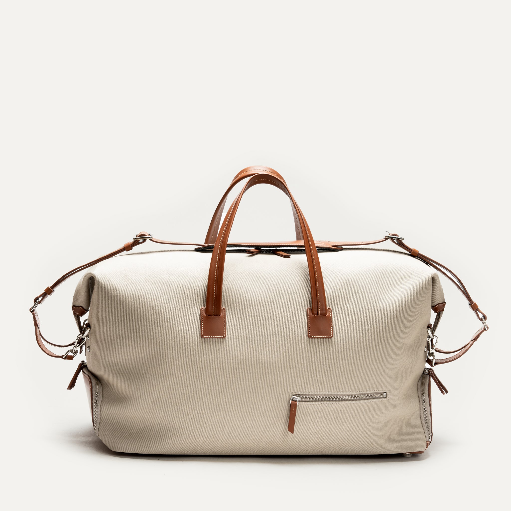 Sac de voyage pour homme beige, élégant et spacieux, avec poignées en cuir marron.