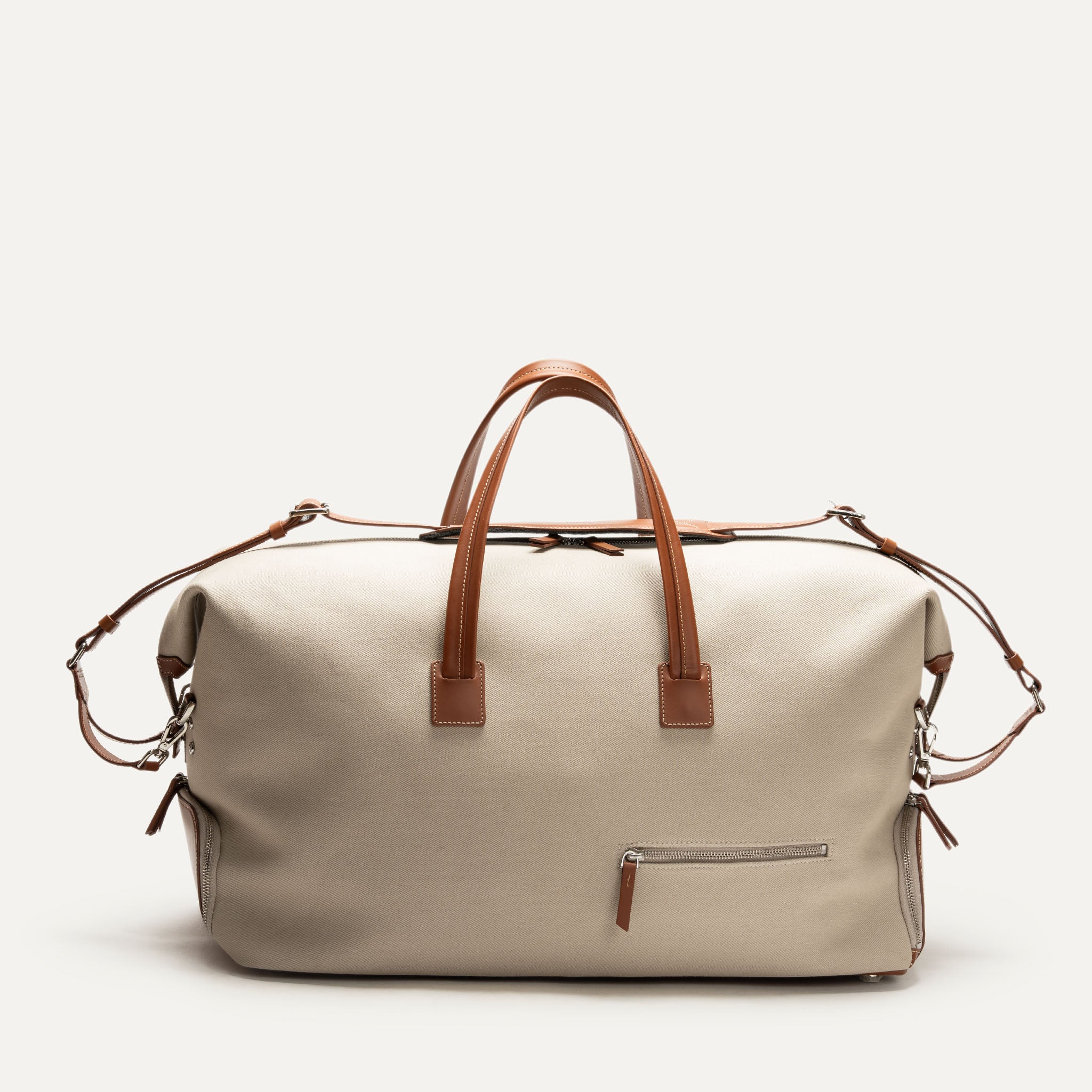 Sac de voyage pour homme beige, élégant et spacieux, avec poignées en cuir marron.