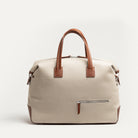 Sac week end pour homme en toile beige et cuir brun, idéal pour courts séjours et usage professionnel.