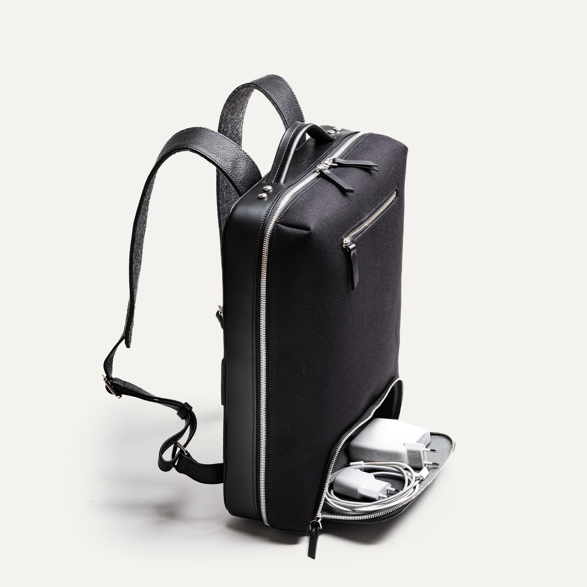 sac à dos tendance homme avec poche basse pour accessoires tech et chargeurs.