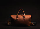 Sac de voyage en cuir cognac est parfait pour les voyages courts, offrant un compartiment pratique pour vos chaussures et votre trousse de toilette.