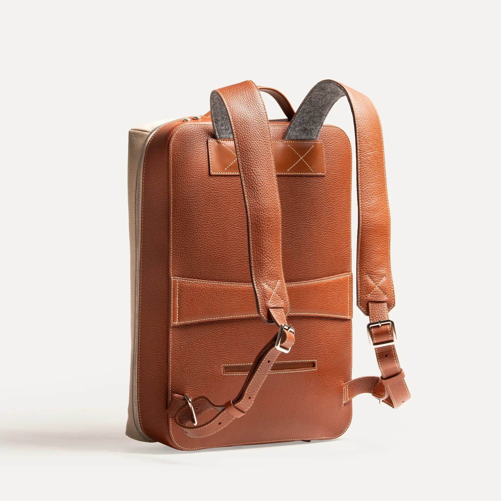 Vue arrière d’un sac à dos travail pour homme, en cuir pleine fleur élégant avec rangement sécurisé du passeport et sangle valise.